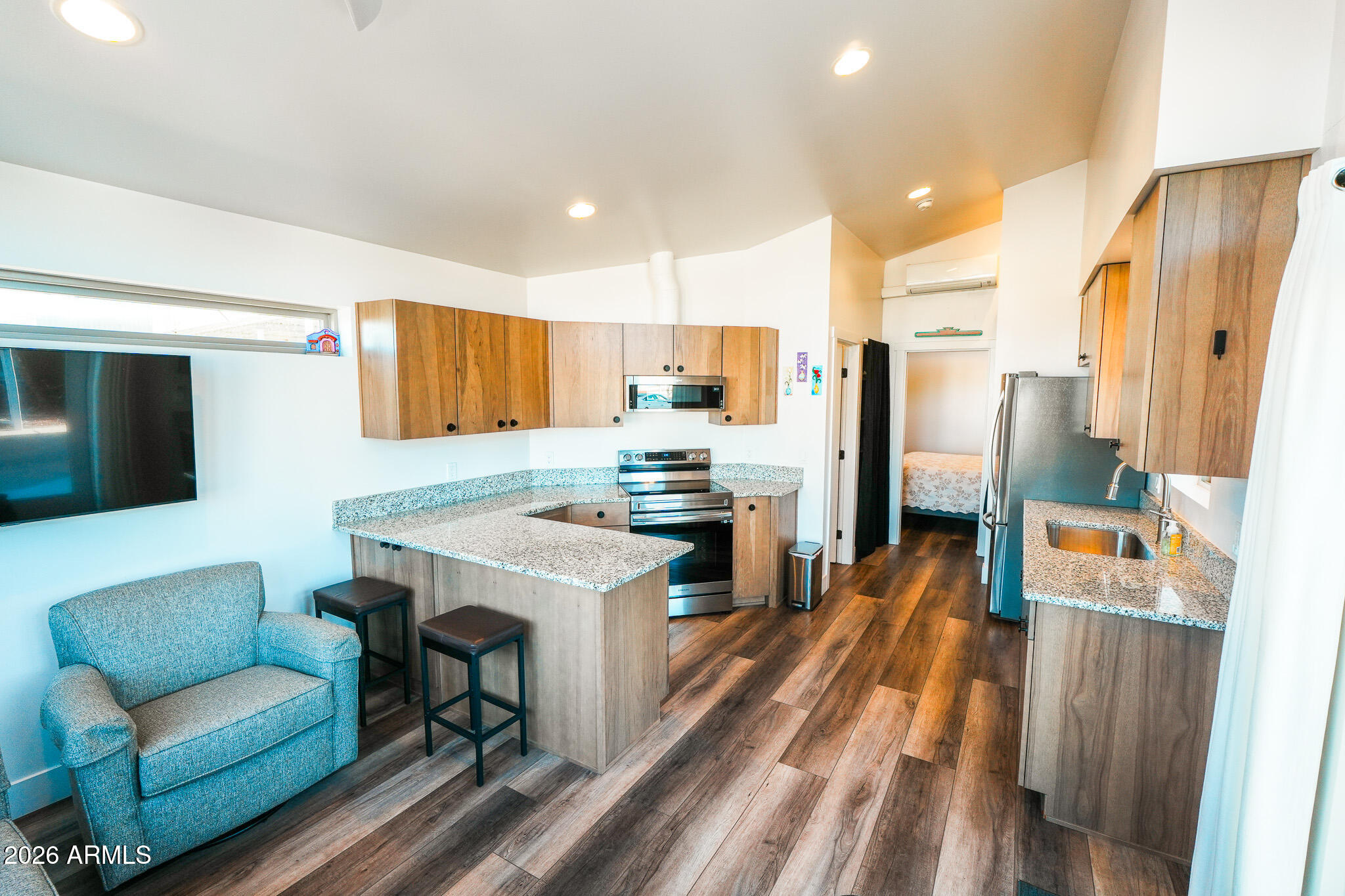 17200 West Bell Road, Unit 554 Surprise, AZ 85374 - Photo 2 of 21 a kitchen with stainless steel appliances kitchen island granite countertop a refrigerator and a stove top oven