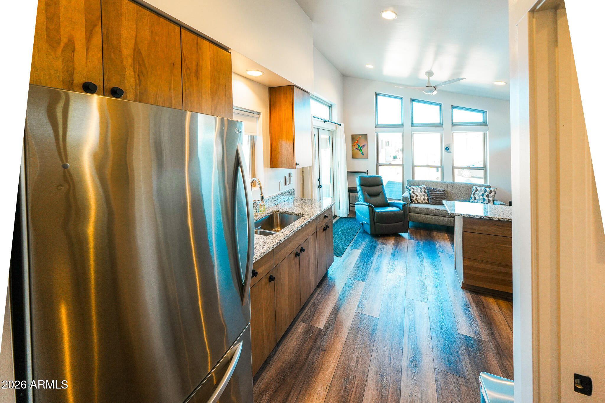 17200 West Bell Road, Unit 554 Surprise, AZ 85374 - Photo 7 of 21 a kitchen with stainless steel appliances granite countertop a refrigerator a stove and a wooden floor
