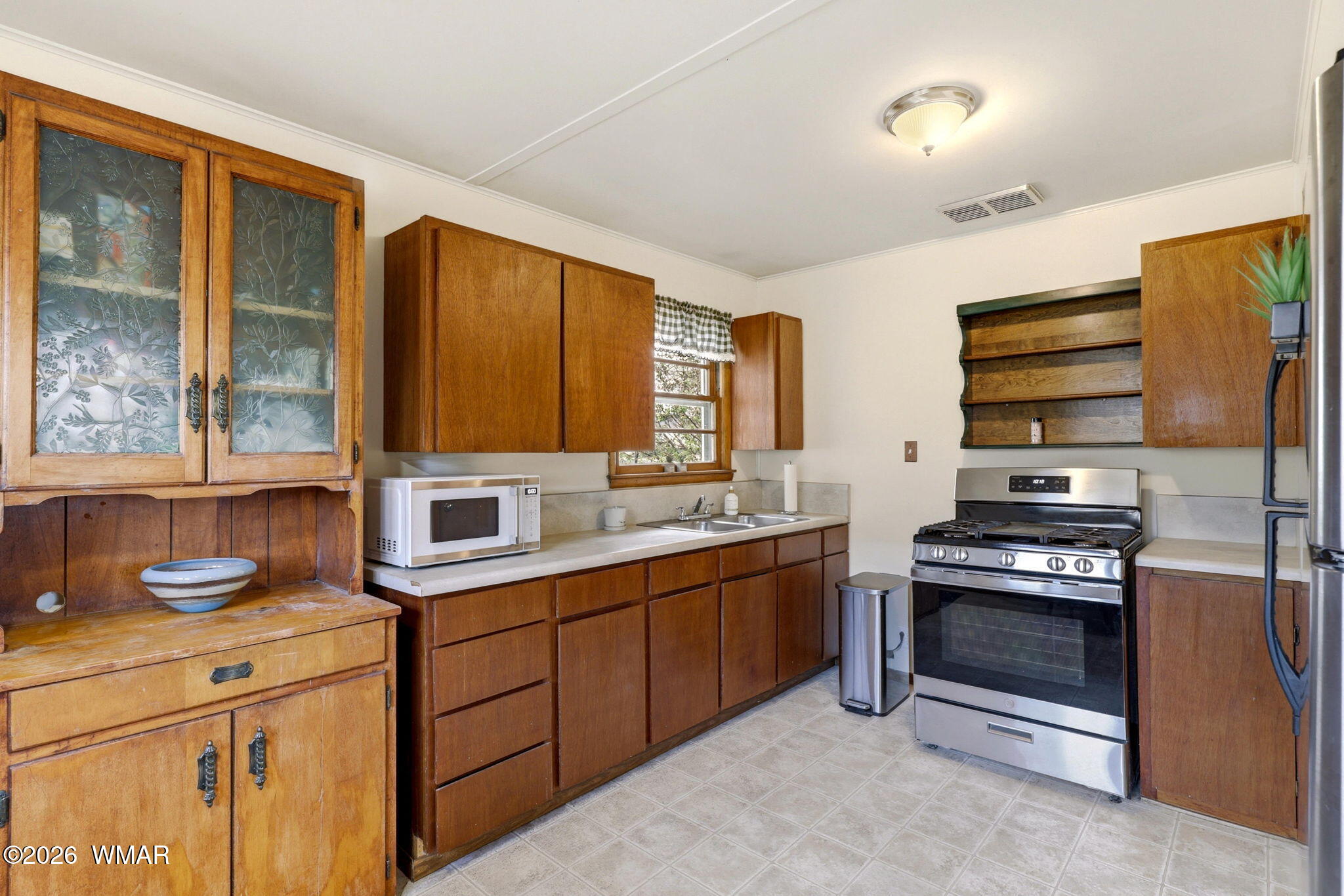 438 East Yaqui Street Springerville, AZ 85938 - Photo 11 of 31 a kitchen with stainless steel appliances a stove sink and cabinets
