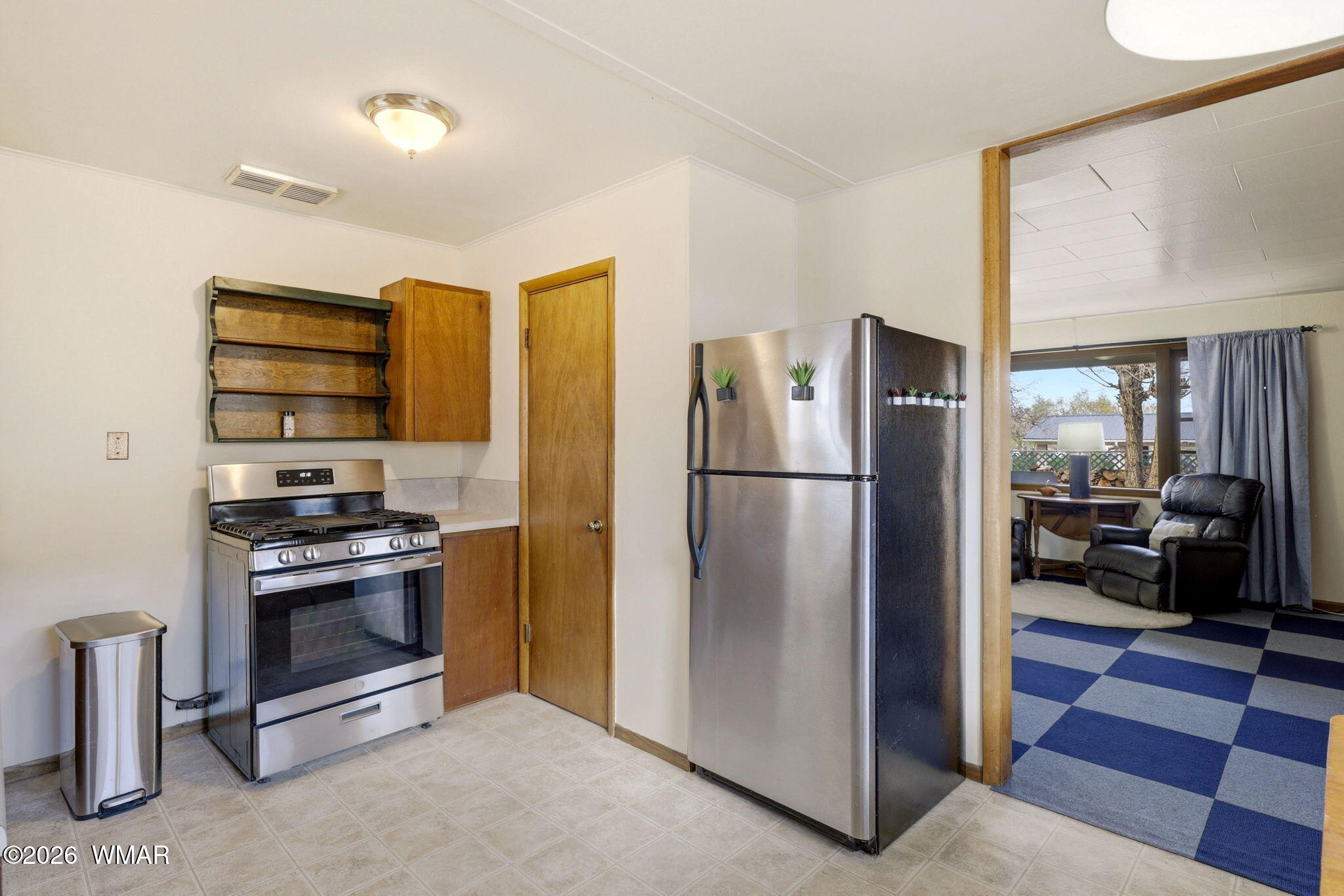 438 East Yaqui Street Springerville, AZ 85938 - Photo 12 of 31 a kitchen with stainless steel appliances granite countertop a refrigerator and a stove top oven