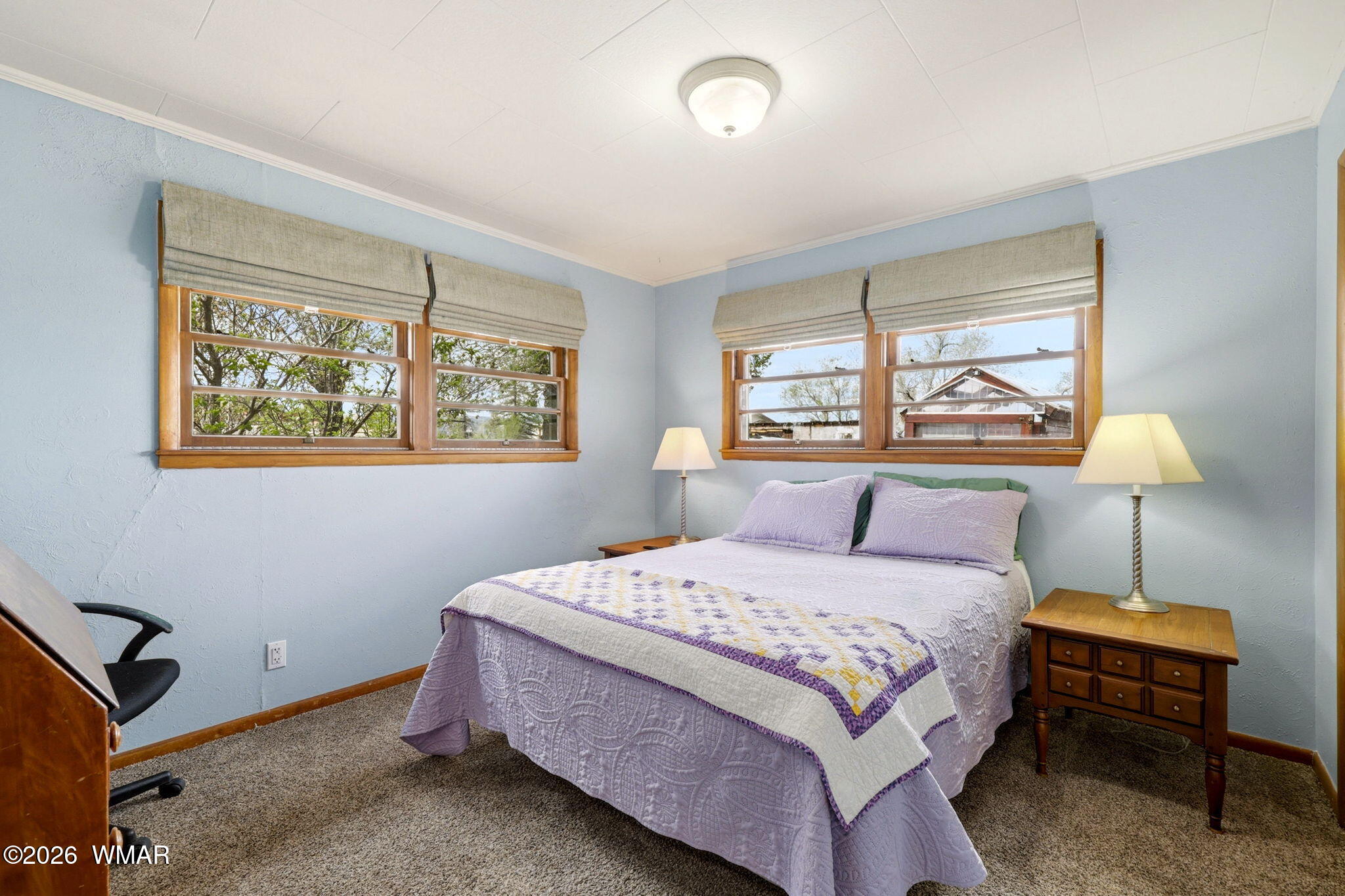 438 East Yaqui Street Springerville, AZ 85938 - Photo 14 of 31 a bedroom with a bed and a window