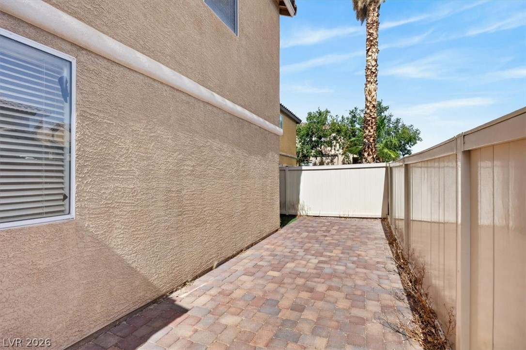 552 Albacate Street Henderson, NV 89015 - Photo 37 of 40 A private side yard features durable paver block surfacing, perfect for outdoor living.