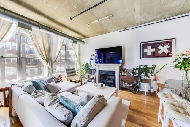 a living room with furniture large window and a fireplace