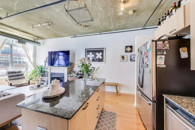 a kitchen with granite countertop lots of counter top space and wooden floor