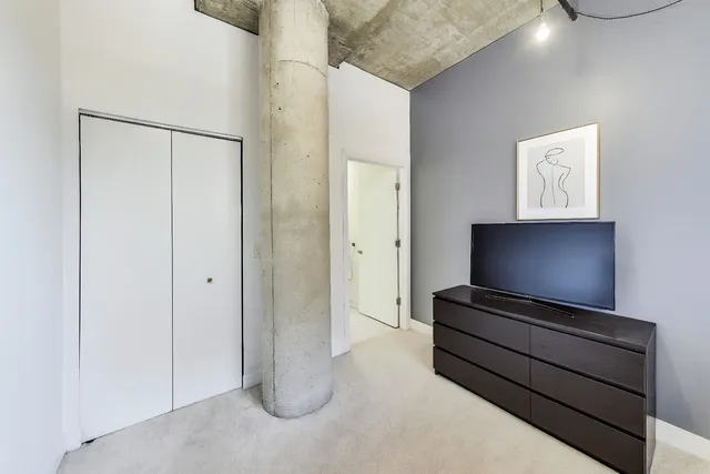 a view of room with wooden floor and cabinet