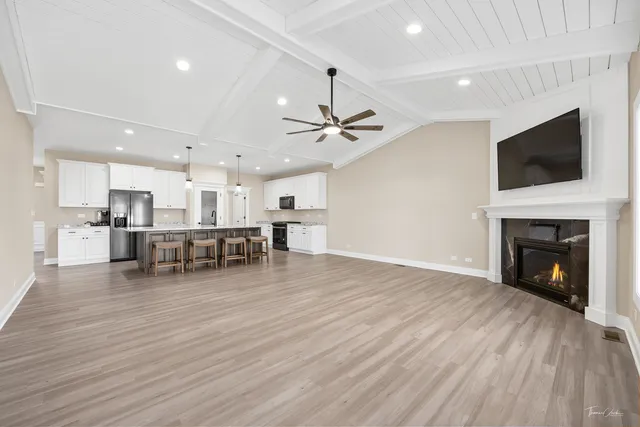 a view of a kitchen with cabinets and wooden floor