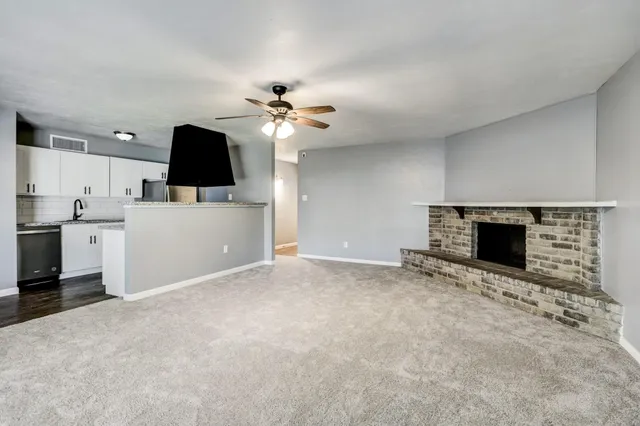 a view of a kitchen with a sink and a fireplace