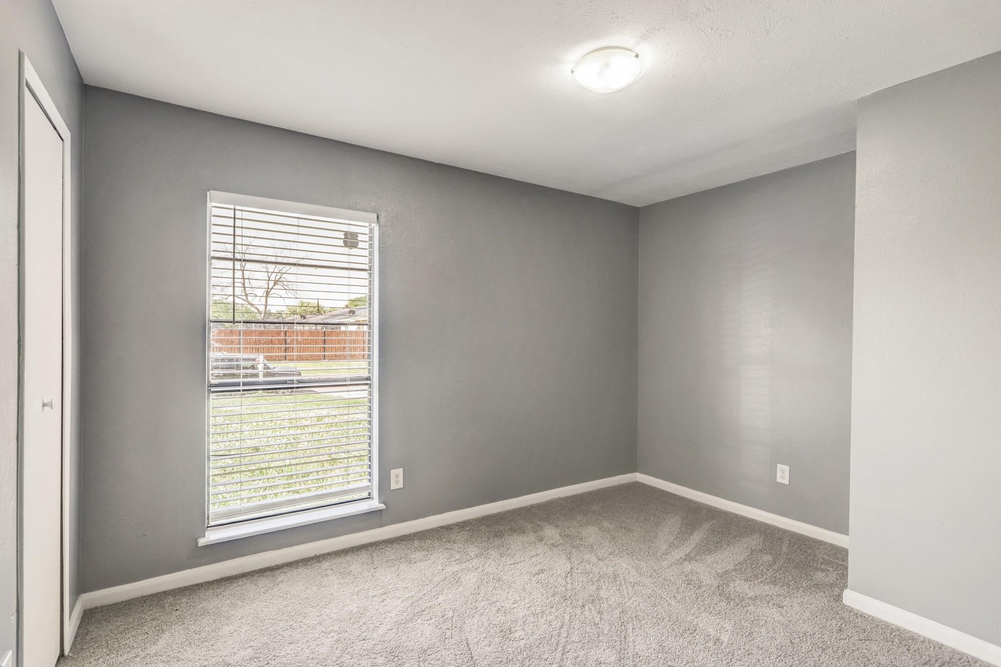 14107 Pinewest Drive Houston, TX 77049 - Photo 5 of 10 an empty room with a window