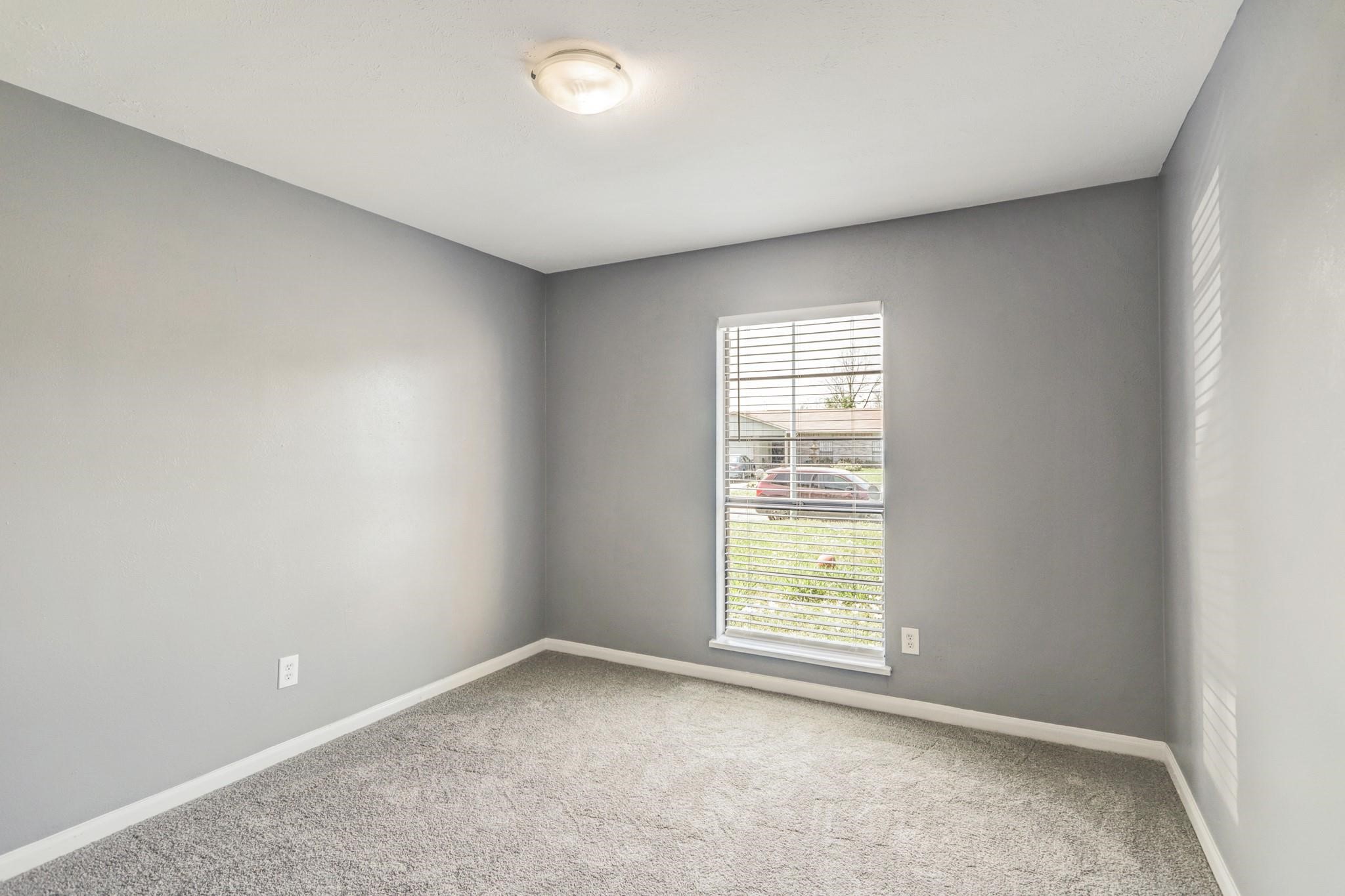 14107 Pinewest Drive Houston, TX 77049 - Photo 6 of 10 an empty room with a window