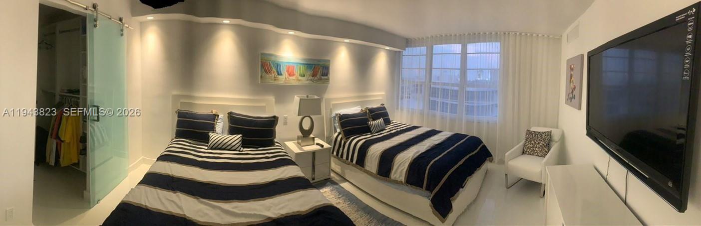 100 Lincoln Road, Unit 1535 Miami Beach, FL 33139 - Photo 2 of 6 a bedroom with a bed and walk in closet
