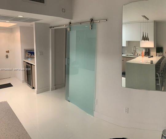 100 Lincoln Road, Unit 1535 Miami Beach, FL 33139 - Photo 3 of 6 a kitchen with a refrigerator and a stove