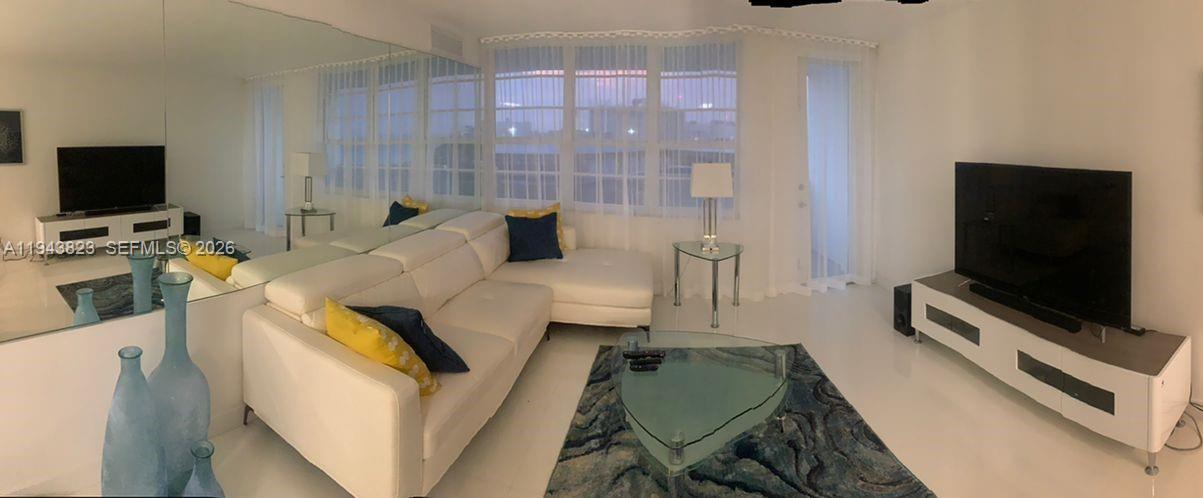 100 Lincoln Road, Unit 1535 Miami Beach, FL 33139 - Photo 6 of 6 a living room with furniture and a flat screen tv