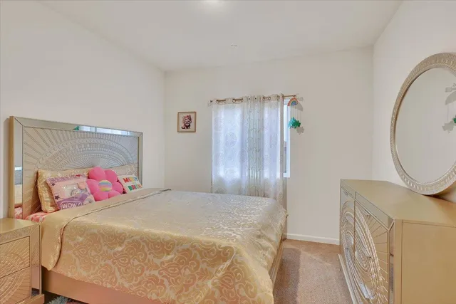 a bedroom with a bed and a mirror