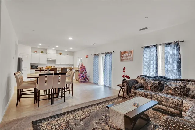 a living room with furniture and kitchen view