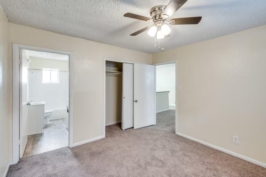 512 South Delaware Street, Unit 1 Irving, TX 75060 - Photo 8 of 9 a view of a big room with a chandelier fan and a bathroom