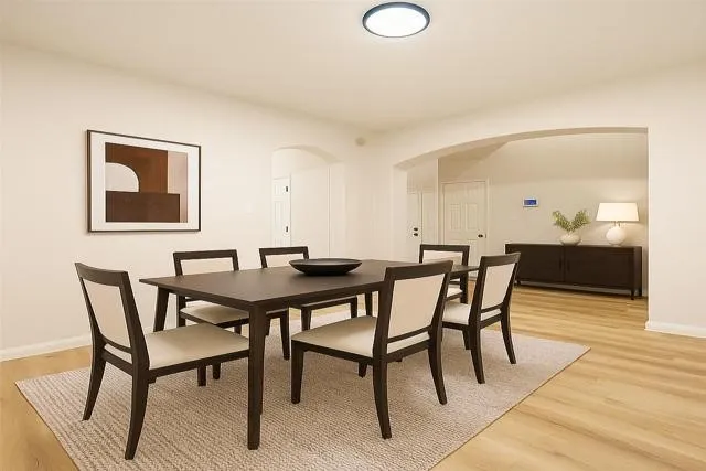 a view of a dining room with furniture and wooden floor