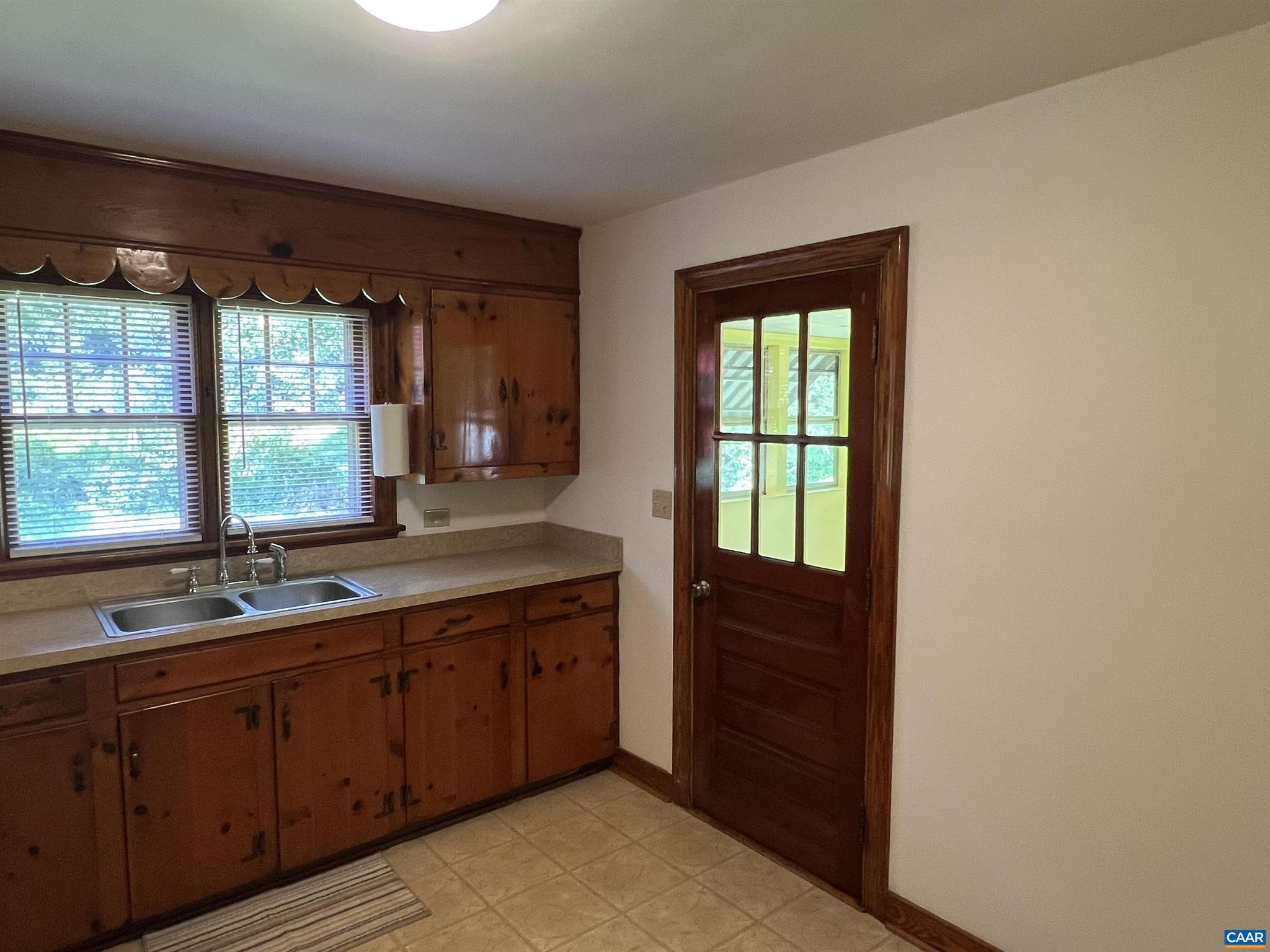 1320 Avon Street Charlottesville, VA 22902 - Photo 12 of 40 a bathroom with a double vanity sink and large window