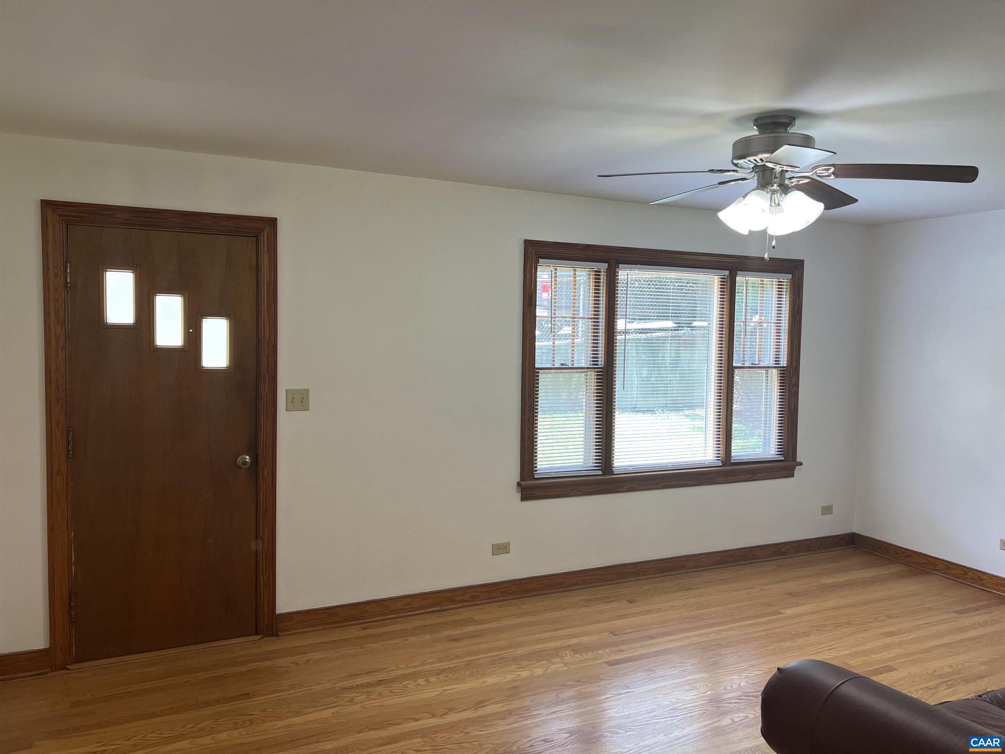 1320 Avon Street Charlottesville, VA 22902 - Photo 3 of 40 a view of an empty room with wooden floor and a window