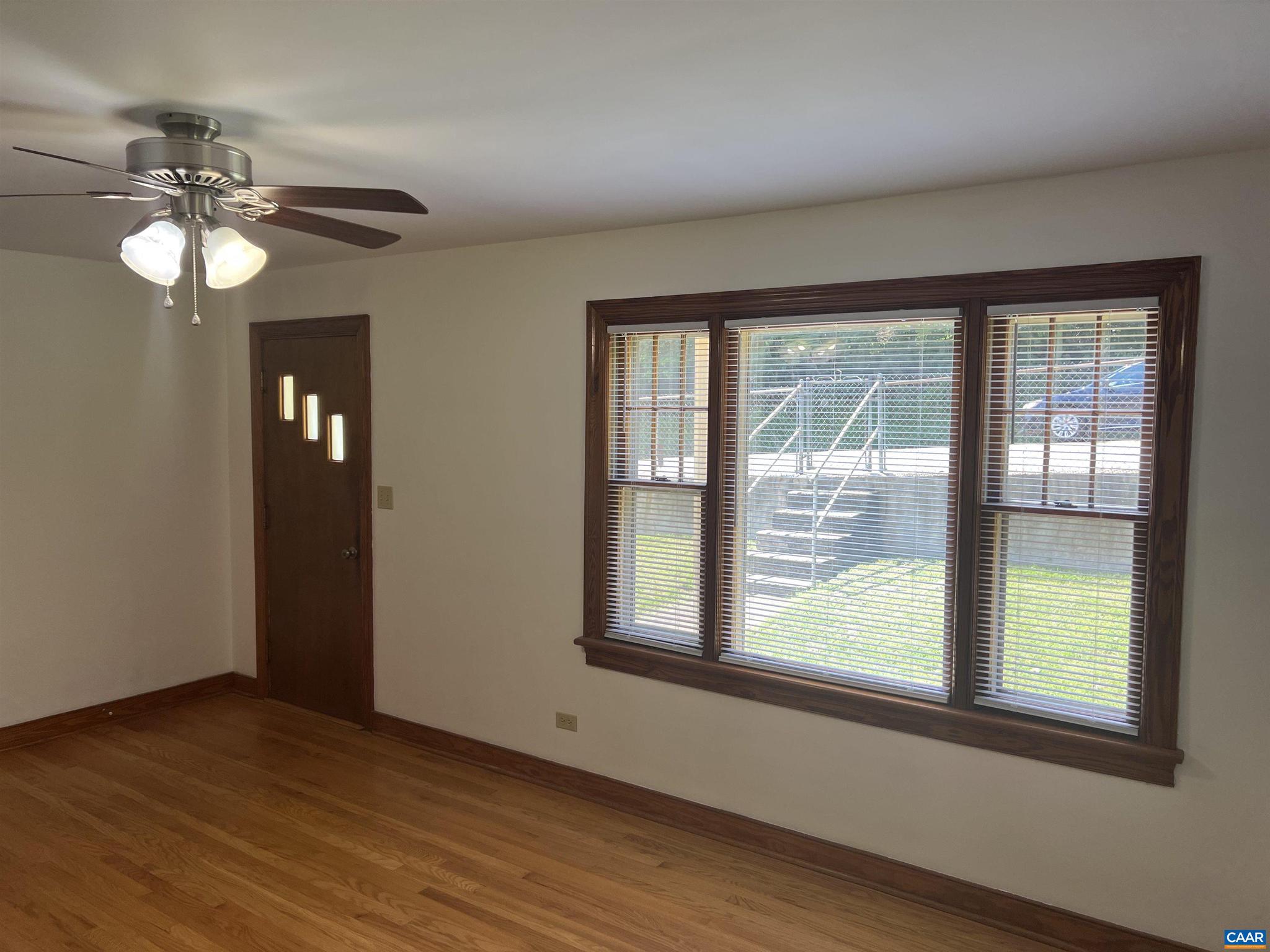 1320 Avon Street Charlottesville, VA 22902 - Photo 4 of 40 a view of an empty room with wooden floor and a window