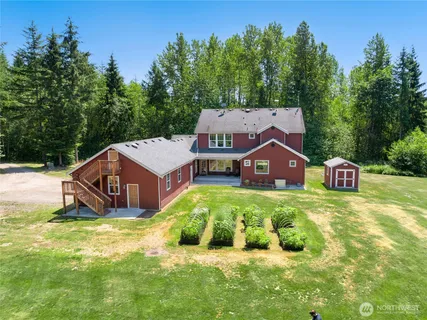 a view of a house with a yard and trees