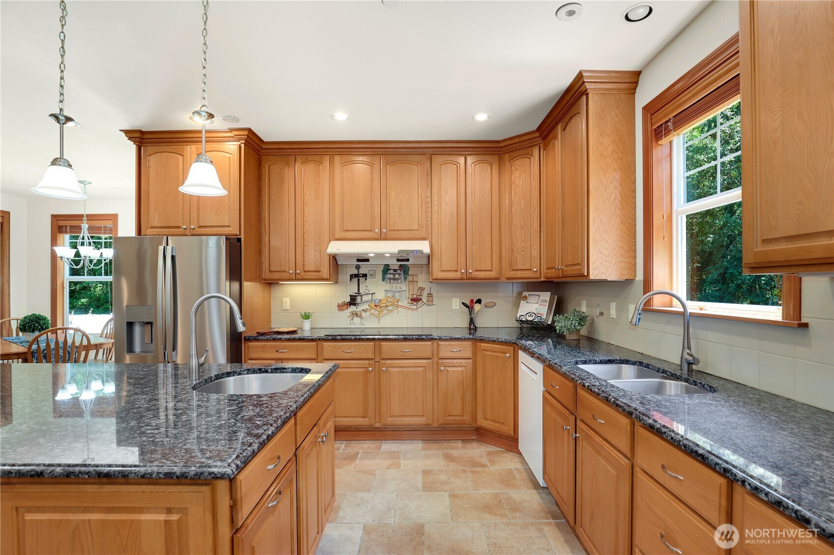 34730 Northeast 82nd Place Carnation, WA 98014 - Photo 8 of 40 a kitchen with kitchen island granite countertop a sink a counter top space and cabinets