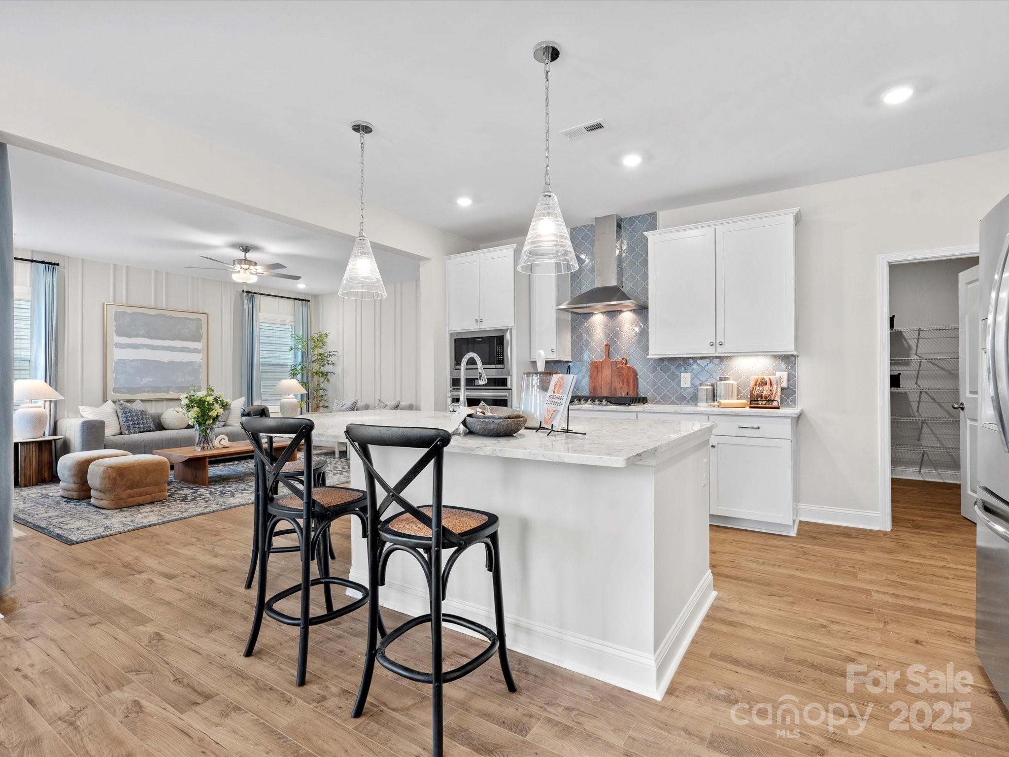 1008 Rocking Horse Road Indian Trail, NC 28079 - Photo 11 of 19 a kitchen with stainless steel appliances kitchen island granite countertop a table chairs and a refrigerator