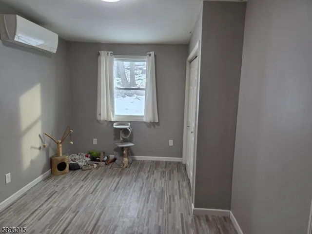 a room with wooden floor and a window