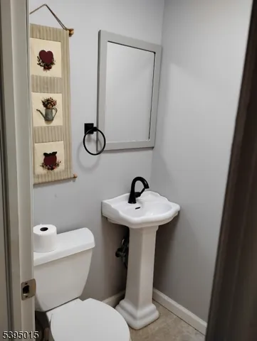 a bathroom with a sink a toilet and shower curtain