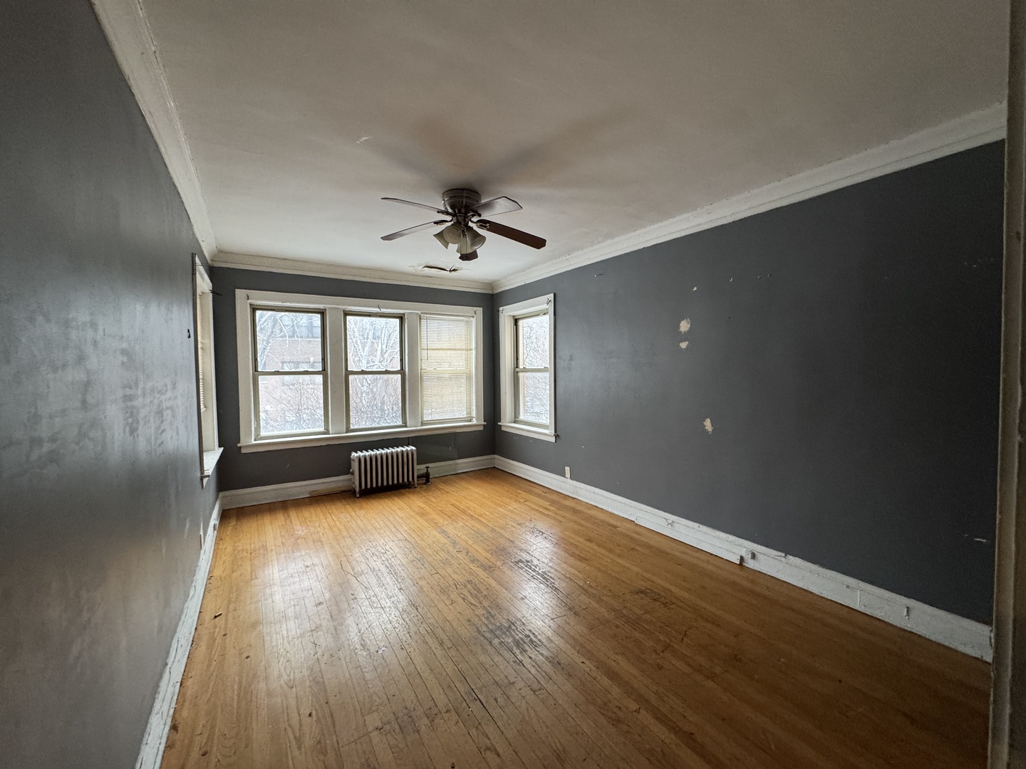 605 East 80th Street Chicago, IL 60619 - Photo 6 of 13 wooden floor in an empty room with a window
