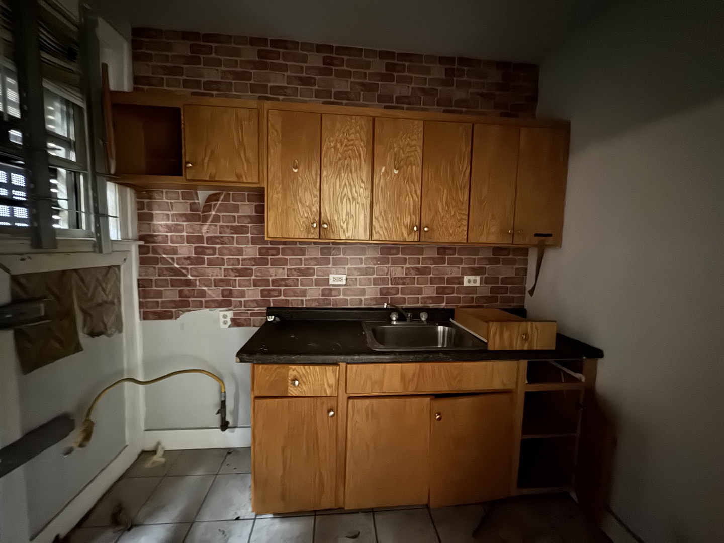 605 East 80th Street Chicago, IL 60619 - Photo 10 of 13 a kitchen with granite countertop a sink a stove and cabinets
