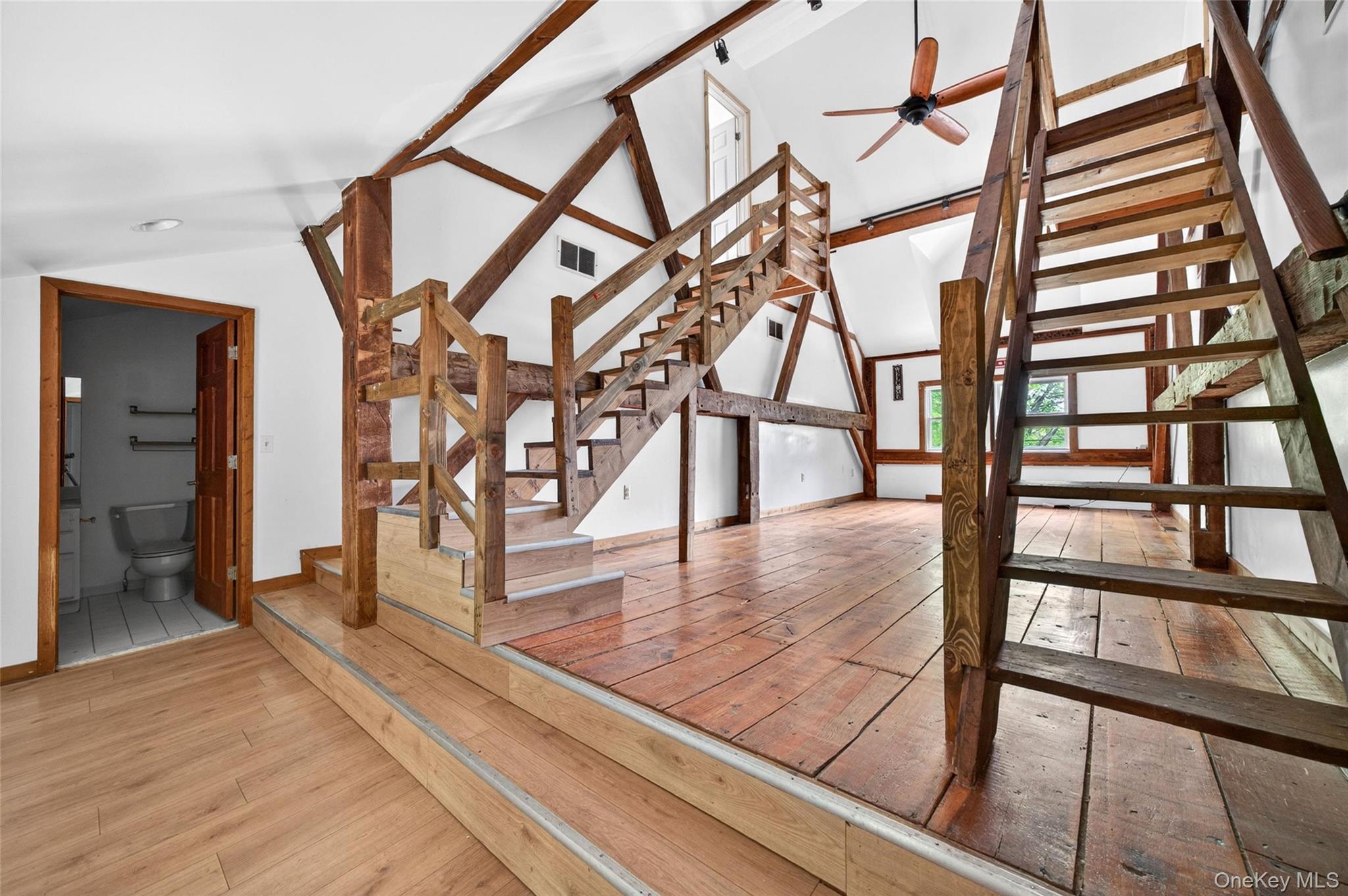 79 Quaker Hill Road, Unit 2 Monroe, NY 10950 - Photo 13 of 32 Exposed timber framing and wood-finish flooring define this multi-level interior