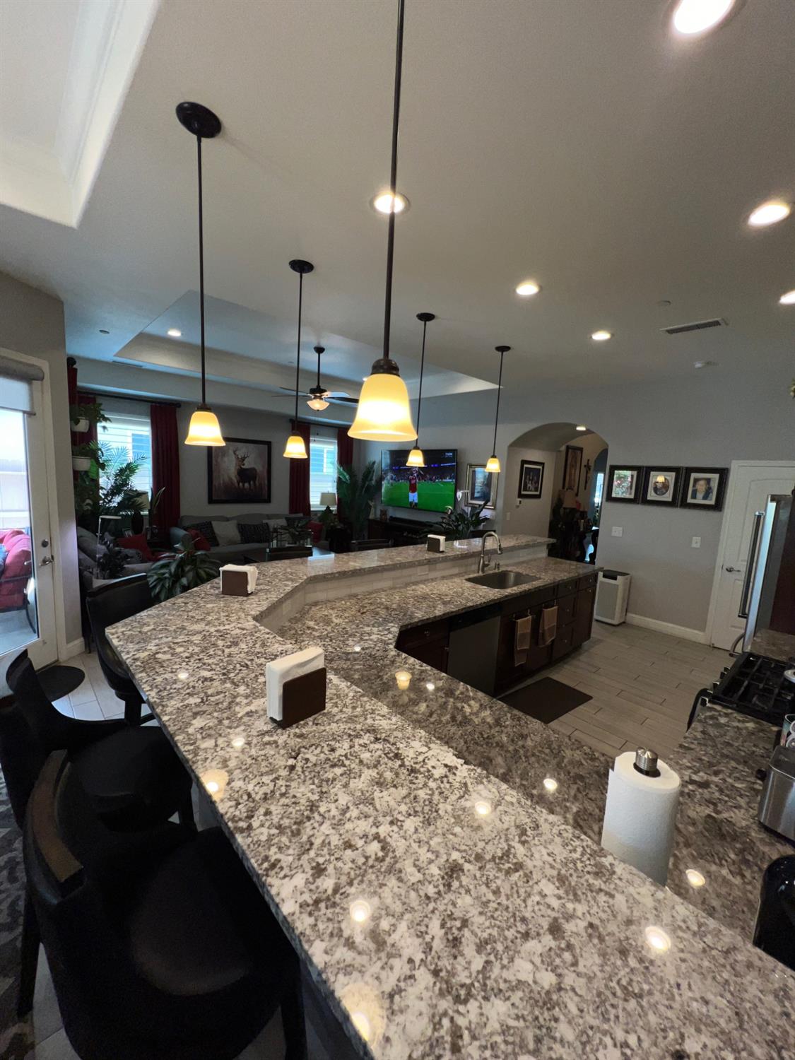 889 Coloma Place Madera, CA 93637 - Photo 20 of 61 a kitchen with stainless steel appliances granite countertop a sink a stove and a wooden floors