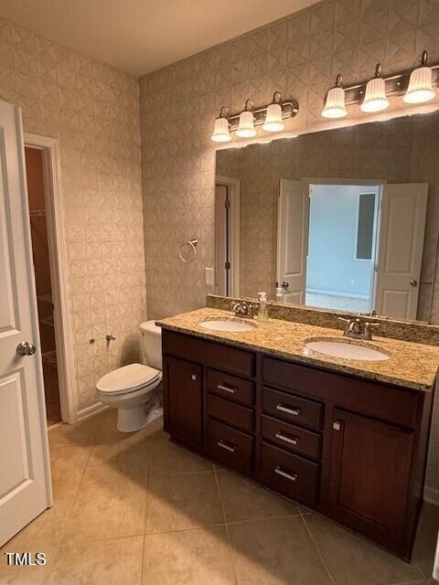 200 Presenteer Trail Apex, NC 27539 - Photo 12 of 17 a bathroom with a granite countertop toilet sink and mirror