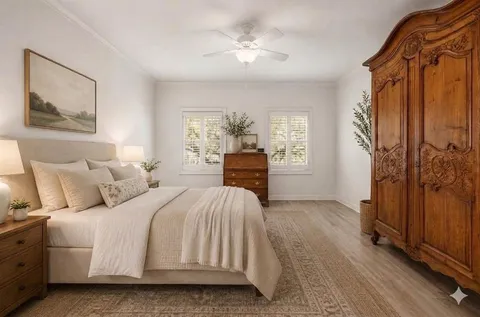 a bedroom with a bed and a chandelier