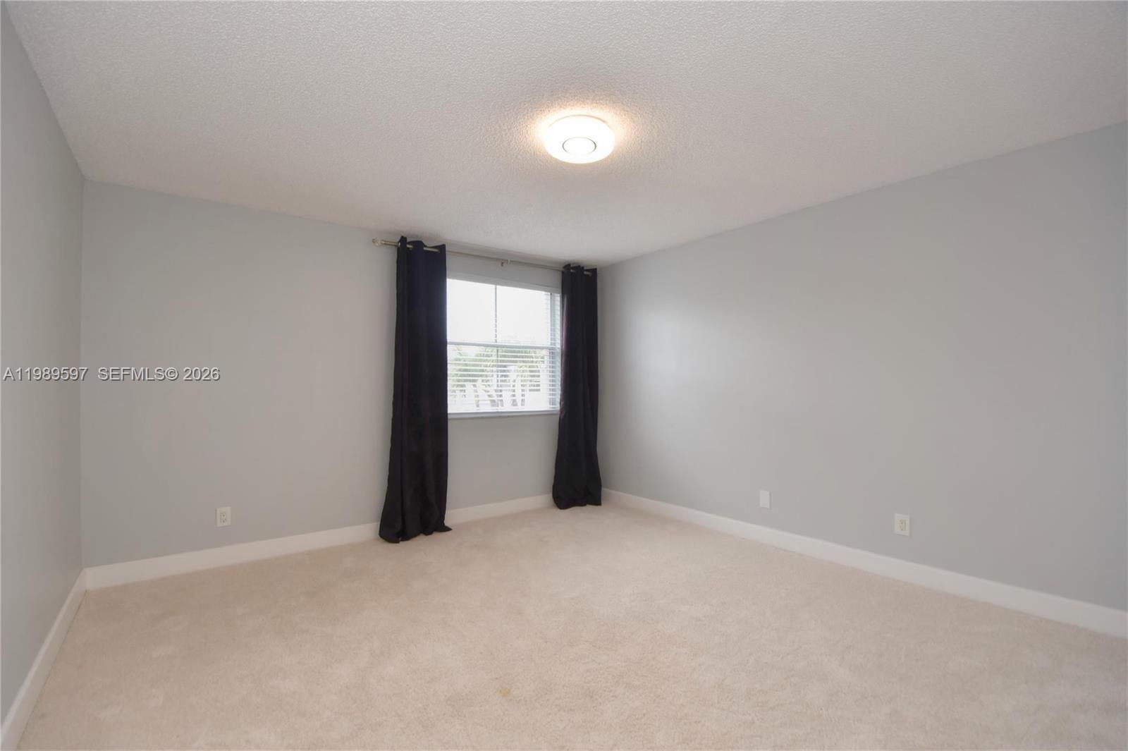 4801 Grapevine Way, Unit 4801 Davie, FL 33331 - Photo 15 of 32 an empty room with windows and closet