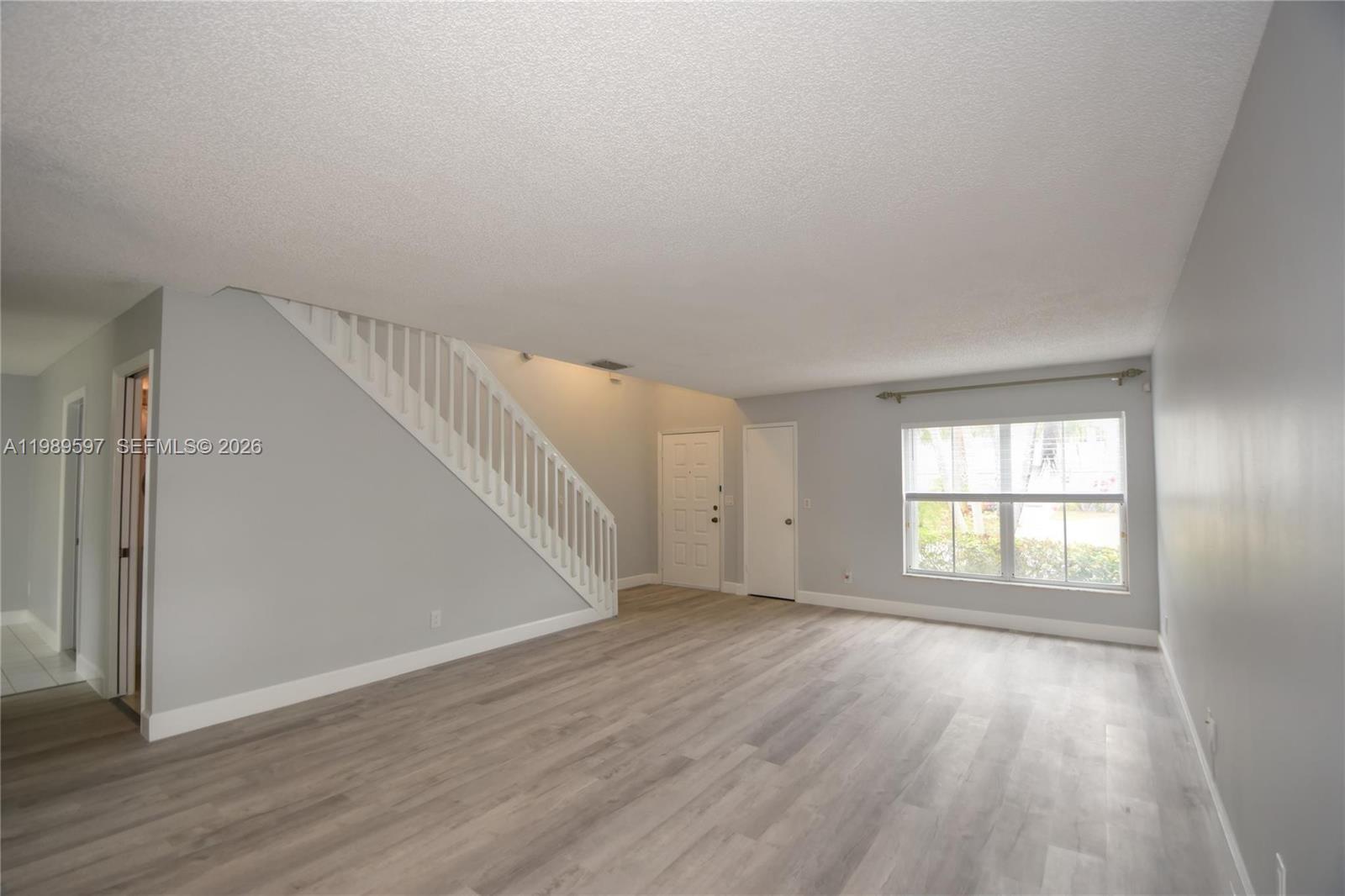 4801 Grapevine Way, Unit 4801 Davie, FL 33331 - Photo 2 of 32 wooden floor in an empty room with a window