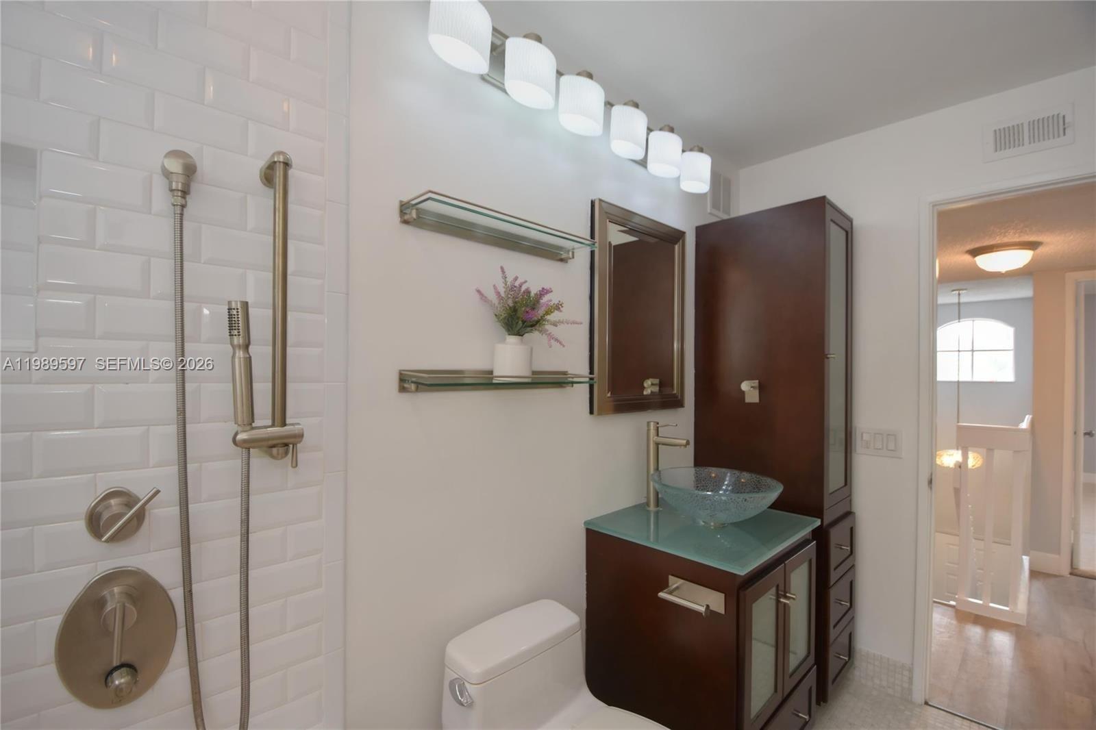 4801 Grapevine Way, Unit 4801 Davie, FL 33331 - Photo 21 of 32 a bathroom with a toilet a sink and shower