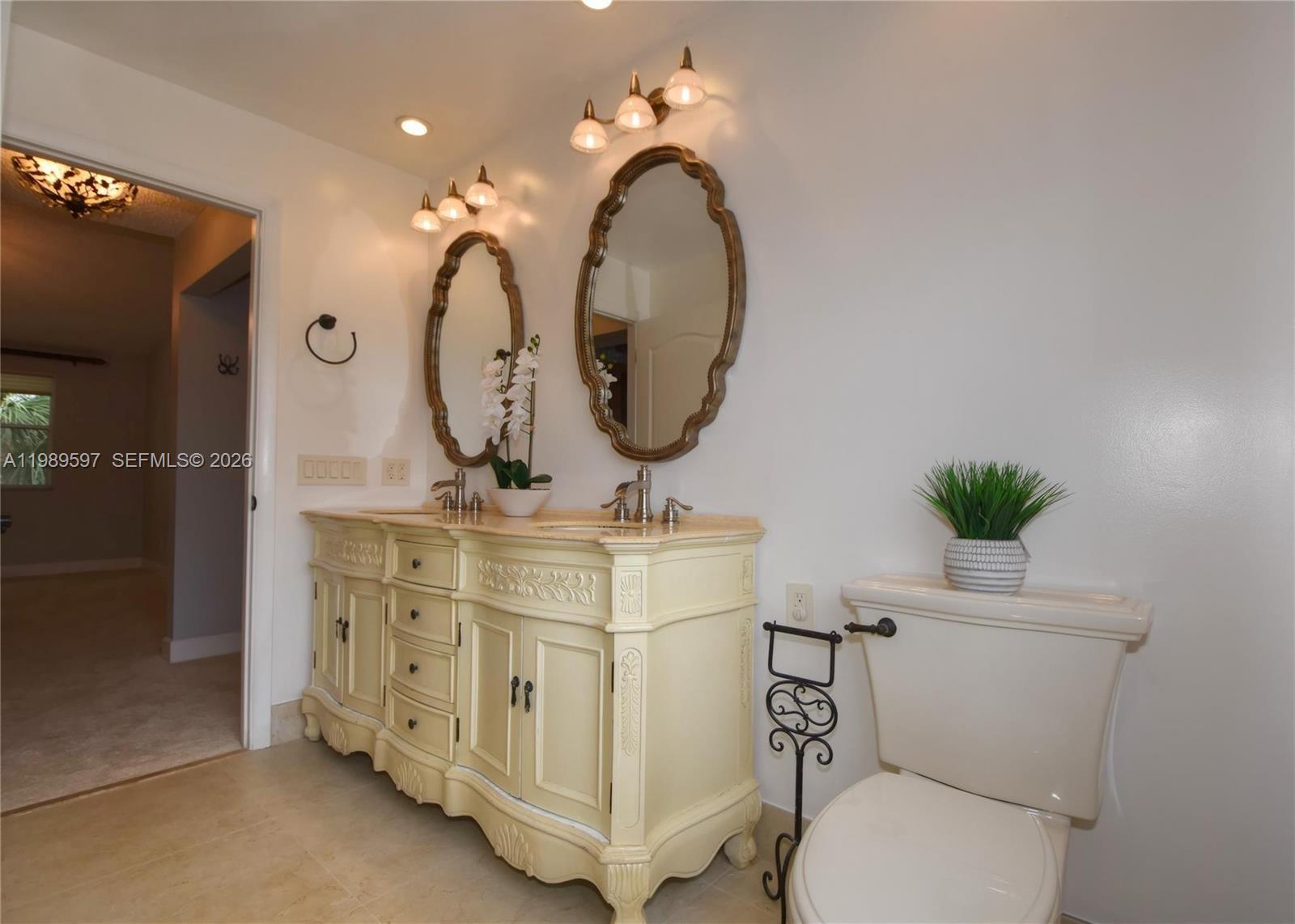 4801 Grapevine Way, Unit 4801 Davie, FL 33331 - Photo 22 of 32 a bathroom with a toilet a sink and a mirror