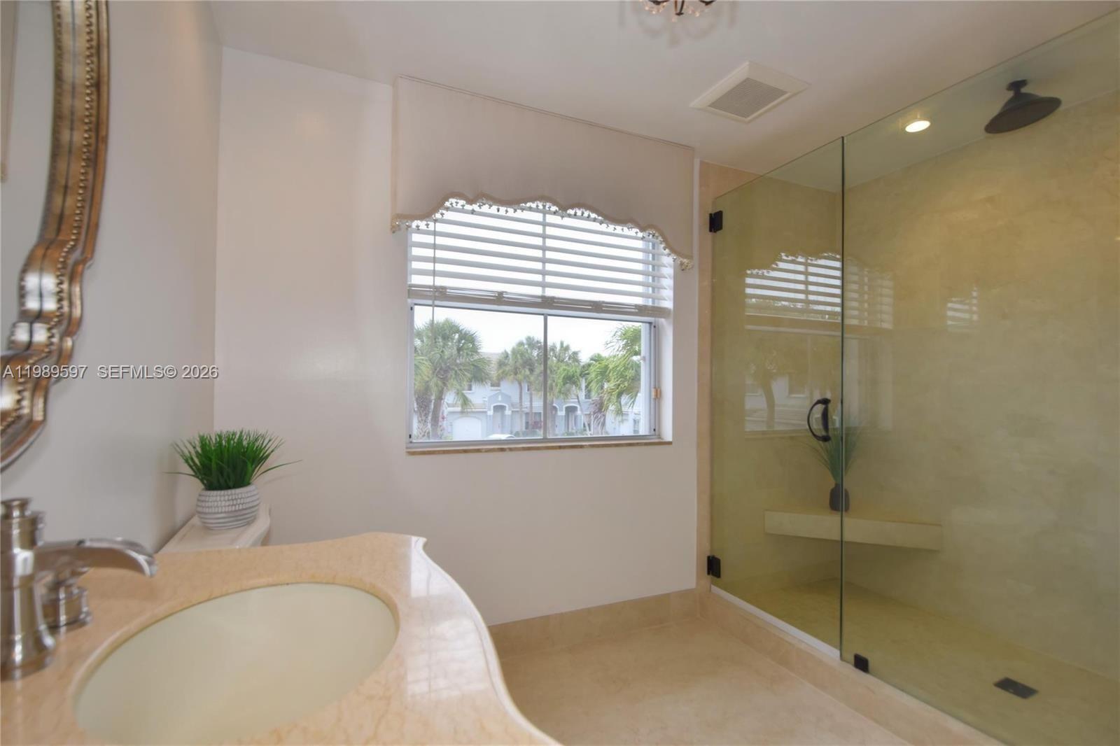 4801 Grapevine Way, Unit 4801 Davie, FL 33331 - Photo 24 of 32 a bathroom with a granite countertop sink a vanity and a shower