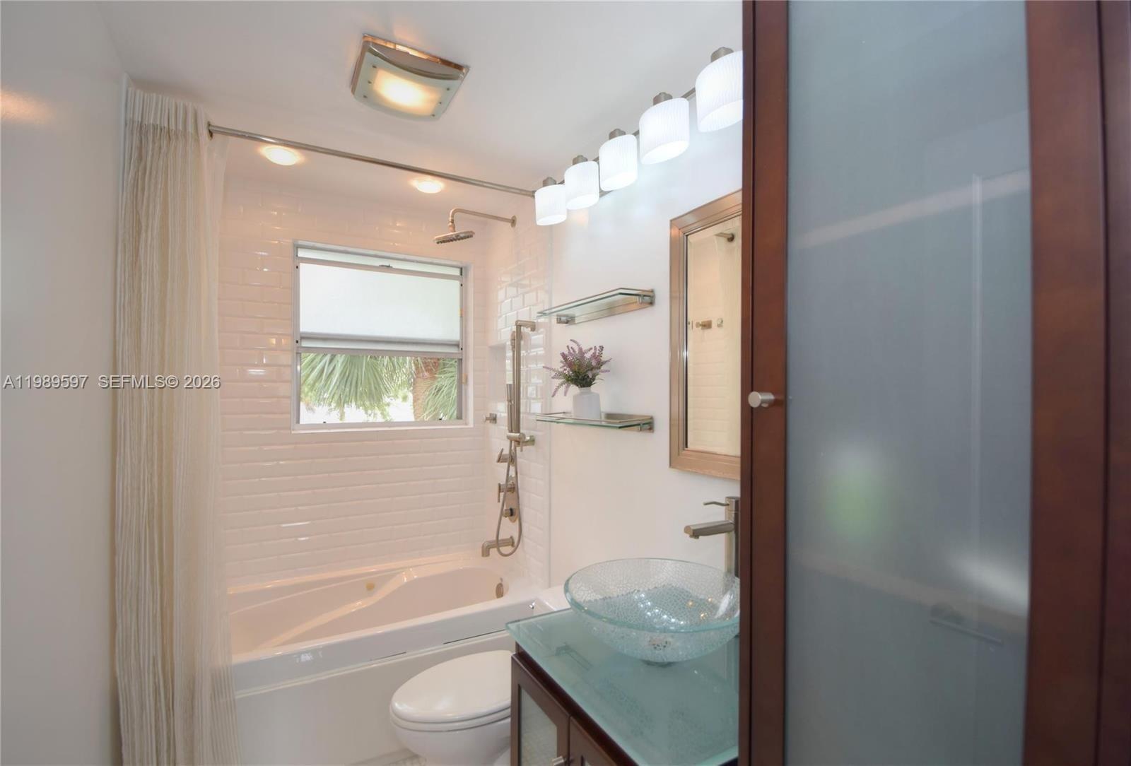 4801 Grapevine Way, Unit 4801 Davie, FL 33331 - Photo 29 of 32 a bathroom with a granite countertop bathtub shower sink and mirror
