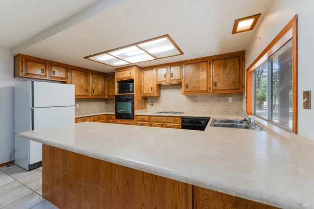 a kitchen with stainless steel appliances a refrigerator and a stove