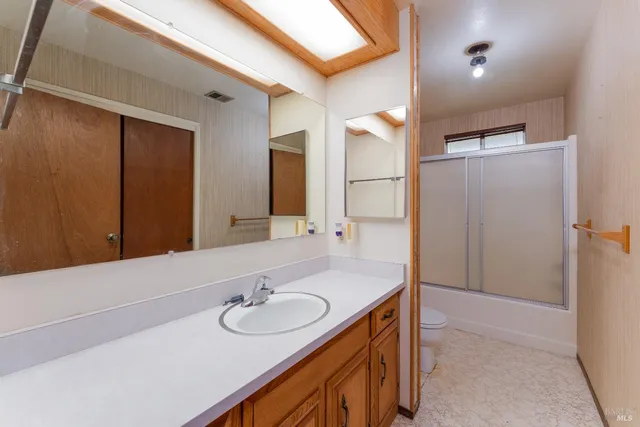 a bathroom with 2 sink and a mirror