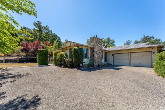 a view of a house with a yard and garage