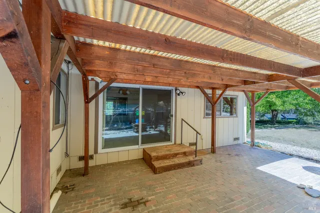 a view of a patio with table and chairs