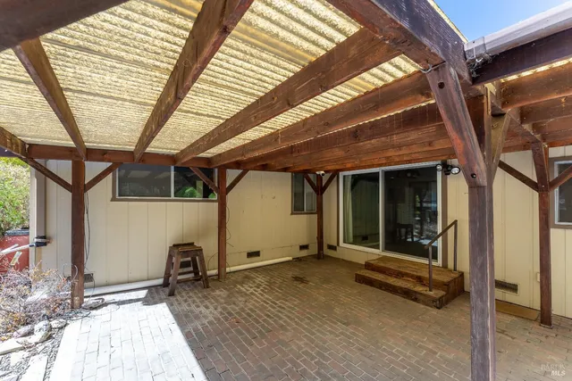 a view of a room with wooden floor and chair