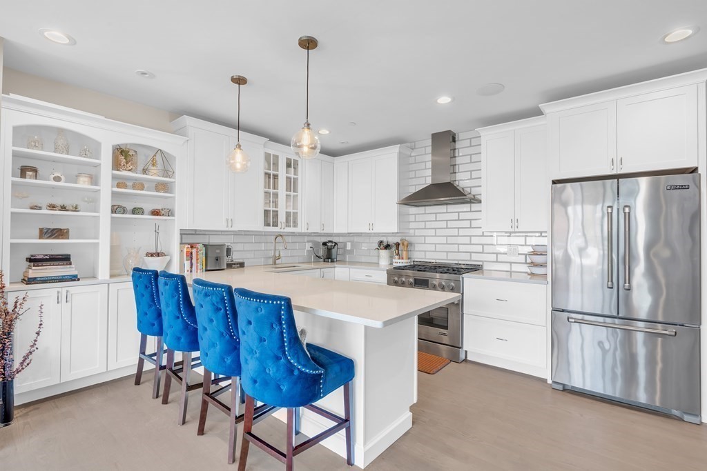 199 West 8th Street, Unit 6 Boston, MA 02127 - Photo 1 of 28 a kitchen with stainless steel appliances granite countertop a refrigerator a sink dishwasher a stove and white cabinets with wooden floor