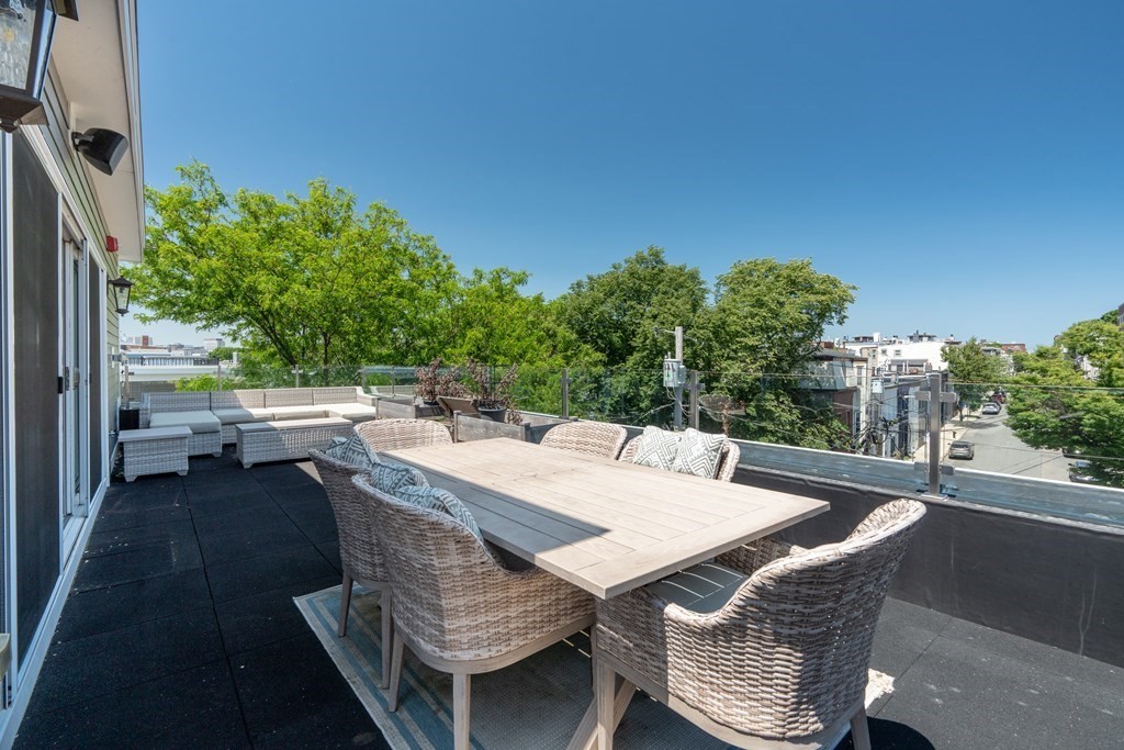 199 West 8th Street, Unit 6 Boston, MA 02127 - Photo 21 of 28 a view of a patio with table and chairs with wooden floor and fence