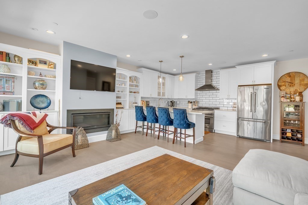 199 West 8th Street, Unit 6 Boston, MA 02127 - Photo 6 of 28 a living room with stainless steel appliances furniture a fireplace a flat screen tv and couches