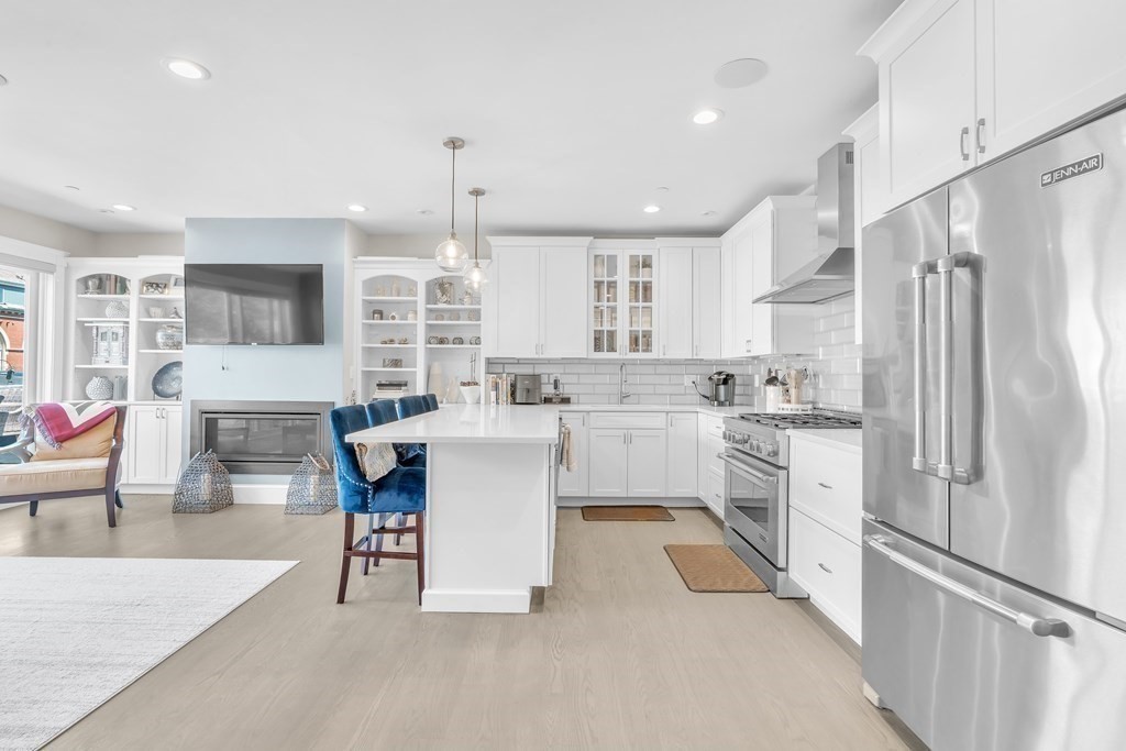 199 West 8th Street, Unit 6 Boston, MA 02127 - Photo 7 of 28 a kitchen with white cabinets and stainless steel appliances