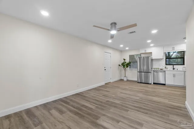 a kitchen with stainless steel appliances a refrigerator a sink a stove a microwave and cabinets